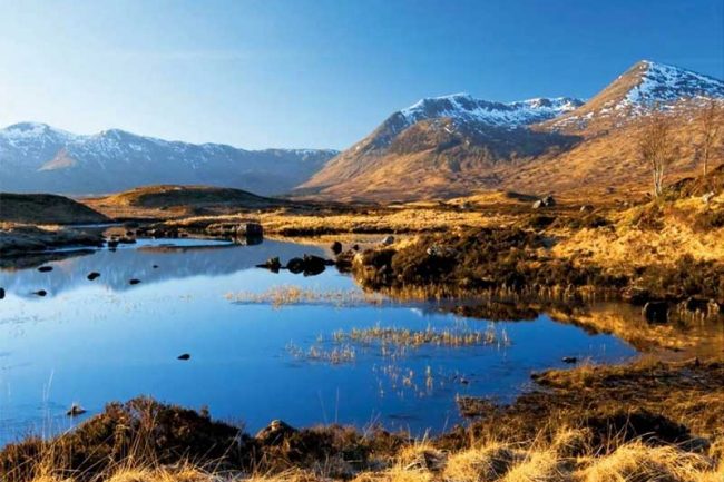 Image of a Scottish Loch with snow peaked hills - perfect spot for a Campervan adventure