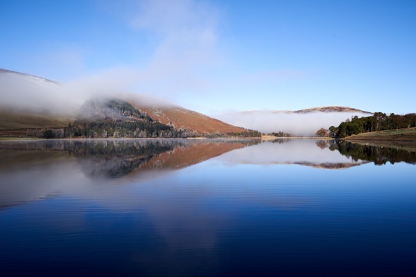 Image of beautiful Scottish loch Scottish Loch with amazing reflection of the sky