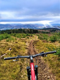 image of glentress mountain MBT Red mountain bike on trail with beautiful view of the Scottish Borders - Scotland motorhome hire